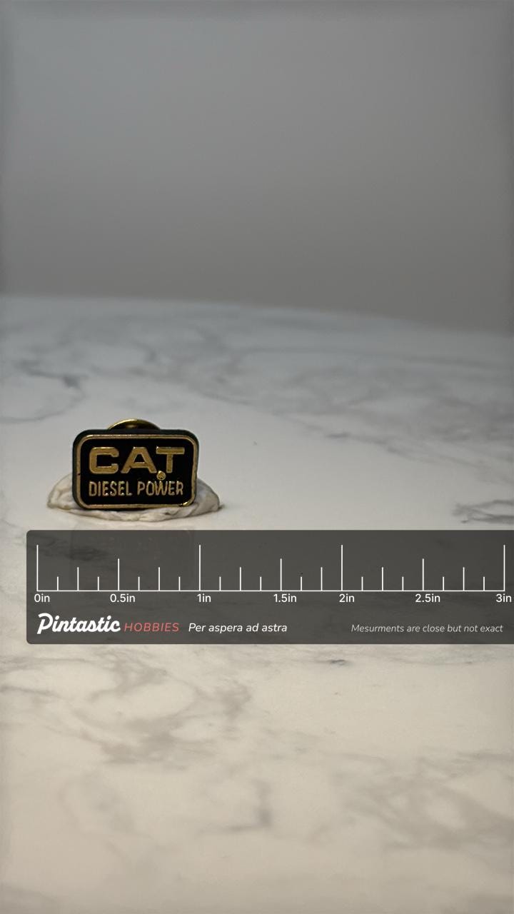 Vintage CAT Diesel Power Enamel Pin: Black & Gold - Tractor Era Accessory with ruler overlay for size reference