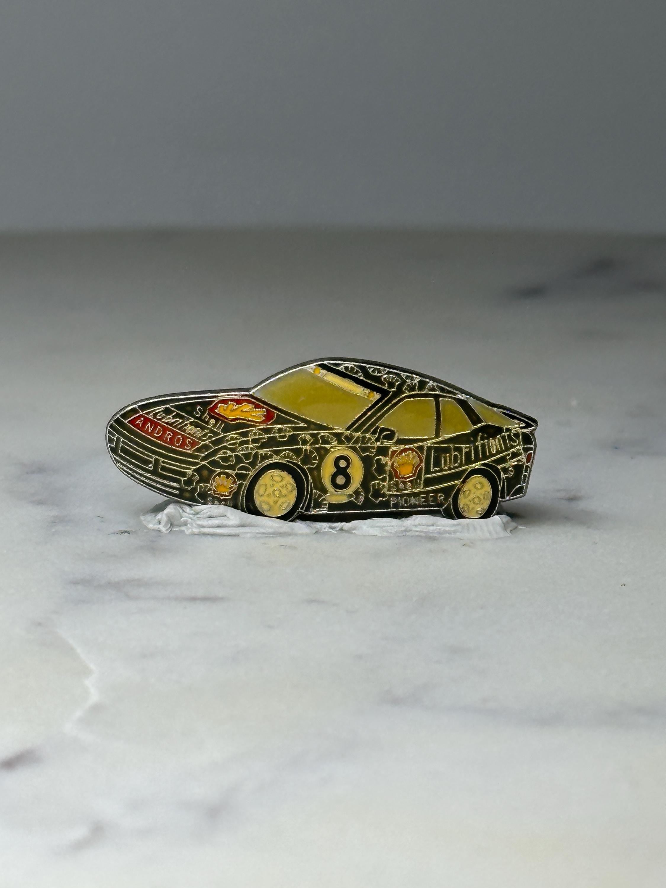 Vintage Shell Race Car Enamel Pin: Black & Gold - 1980s Motorsport Accessory