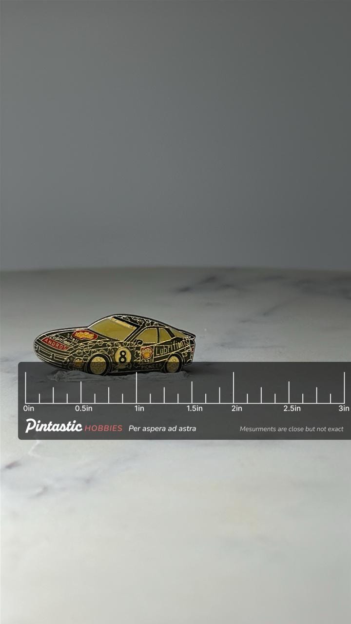 Vintage Shell Race Car Enamel Pin: Black & Gold - 1980s Motorsport Accessory with ruler overlay for size reference