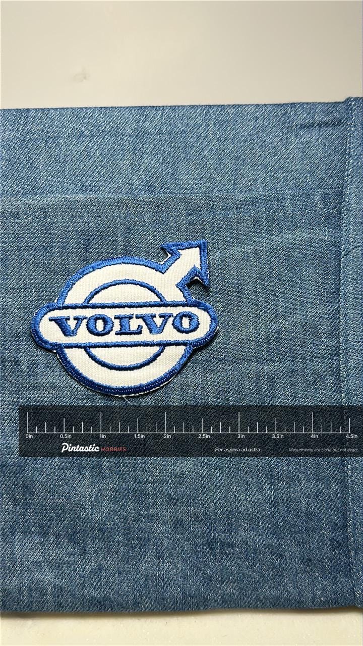 Volvo collectable patch: iron-on blue white - vintage auto accessory with ruler overlay for size reference