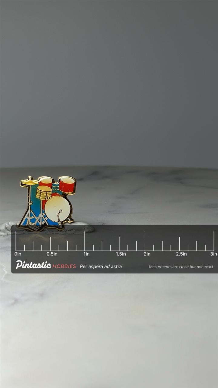 Vintage Drum Set Enamel Pin: Gold Tone - 1980s Music Accessory with ruler overlay for size reference