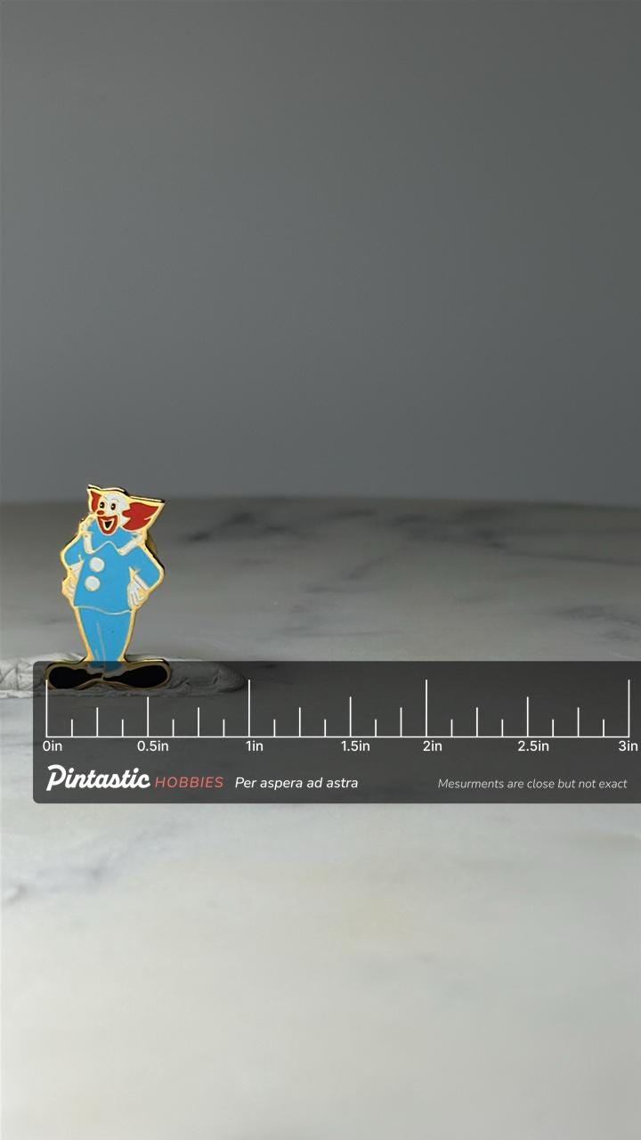 Vintage Clown Character Enamel Pin: Gold Tone - Circus Theme Accessory with ruler overlay for size reference