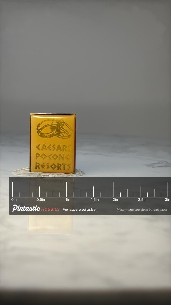 Vintage Caesars Pocono Resorts Pin: Gold Tone Enamel - 1970s Travel Accessory with ruler overlay for size reference