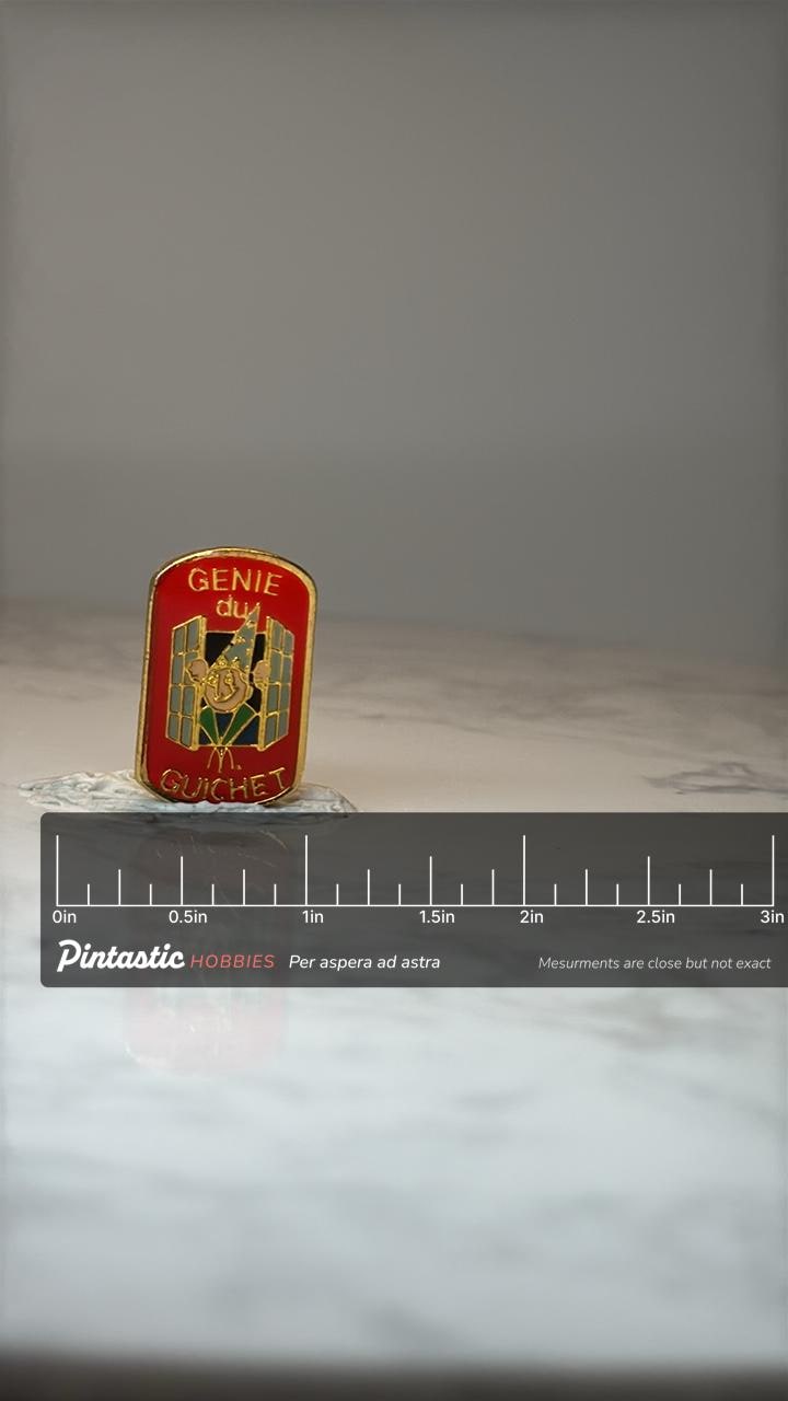 French McDonalds Genie du Guichet Enamel Pin: Red Gold Tone - French Corporate Accessory with ruler overlay for size referenc
