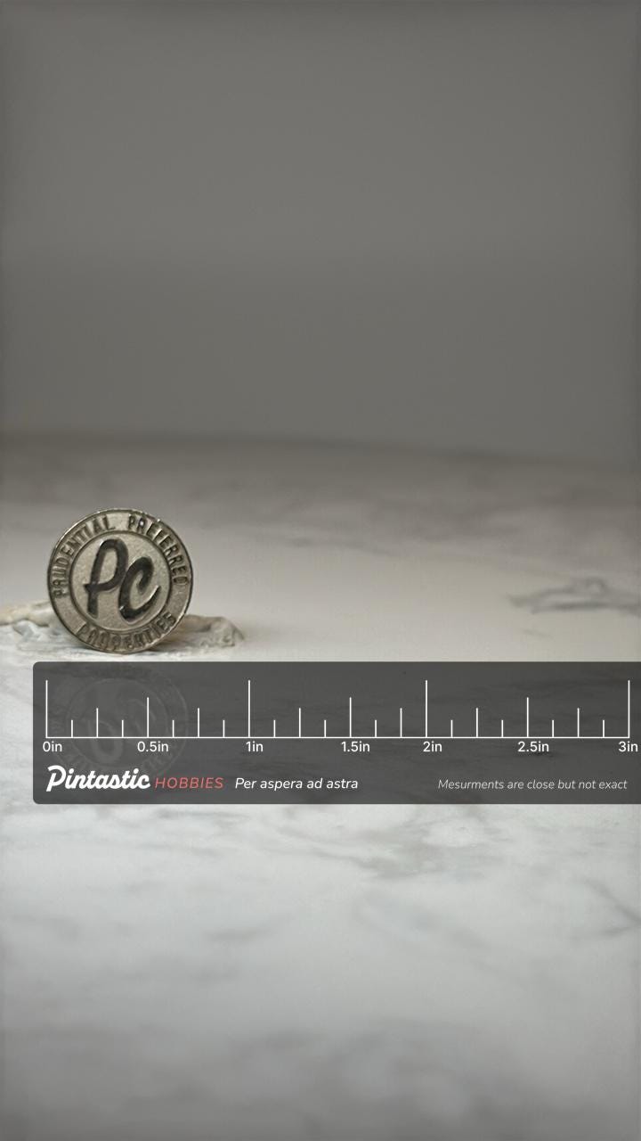 Vintage Prudential Properties Pin: Silver Tone - 1990s Corporate Accessory with ruler overlay for size reference