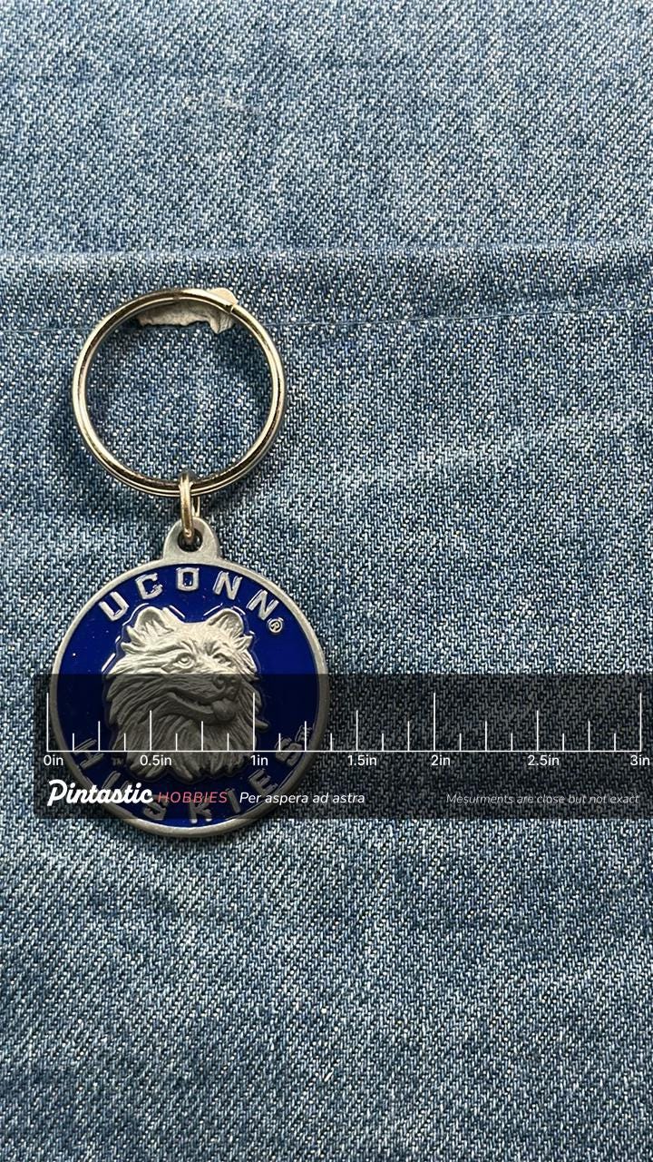 Vintage UConn Huskies Keychain: Blue Enamel Metal - NCAA College Accessory with ruler overlay for size reference