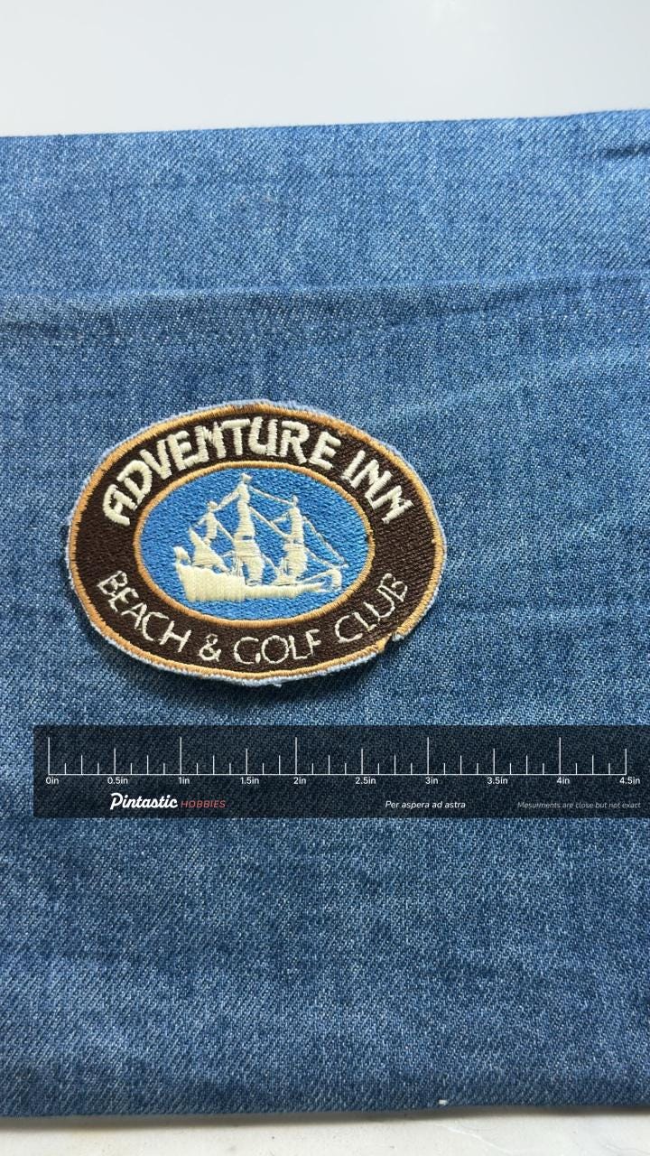 Adventure Inn Patch: Brown and Blue Oval - Beach & Golf Club with ruler overlay for size reference
