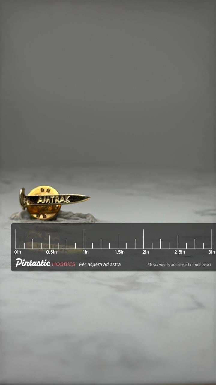 Amtrak Railroad Spike Pin: Gold Tone - Vintage Rail Accessory with ruler overlay for size reference