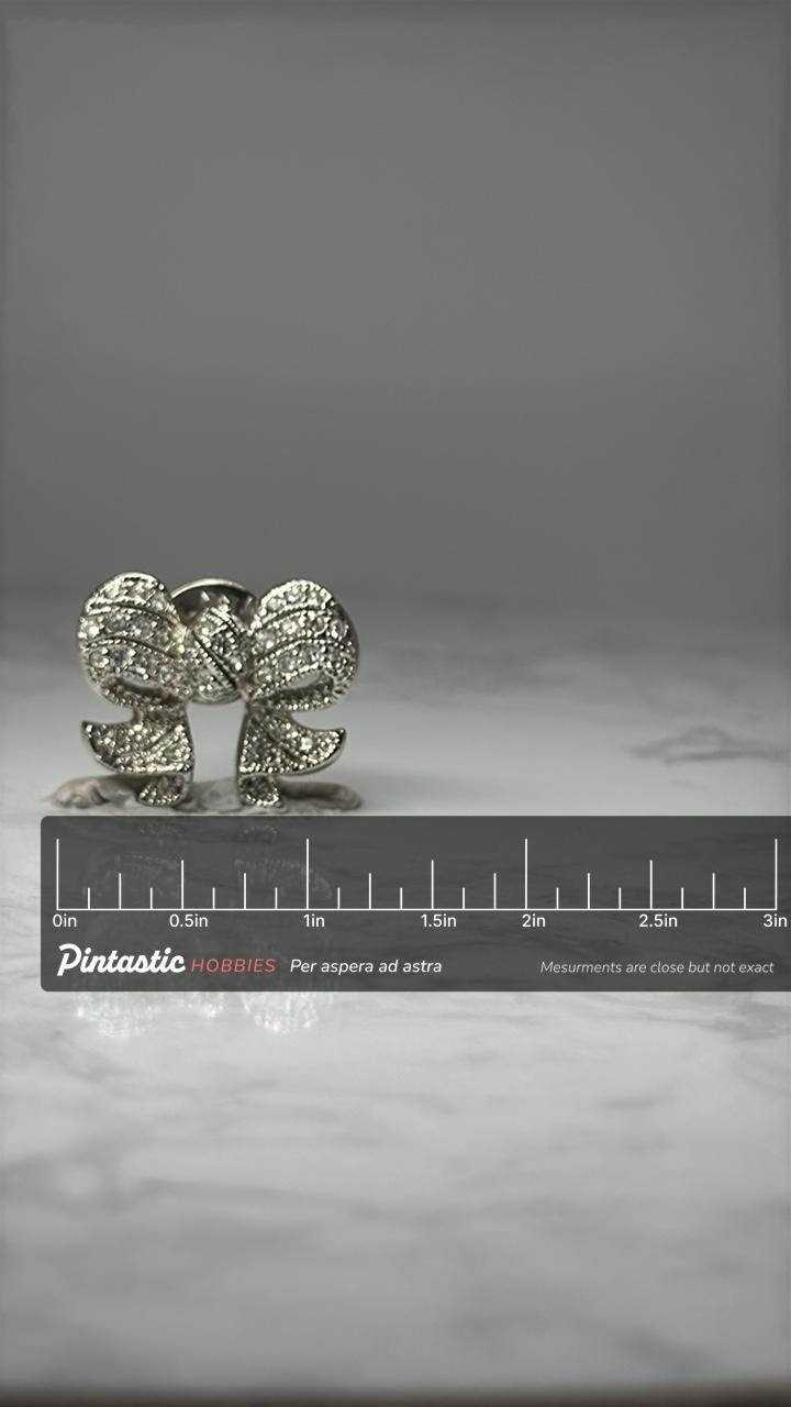 Rhinestone Bow Brooch Pin: Silver Tone Crystal - Vintage Glam Accessory with ruler overlay for size reference