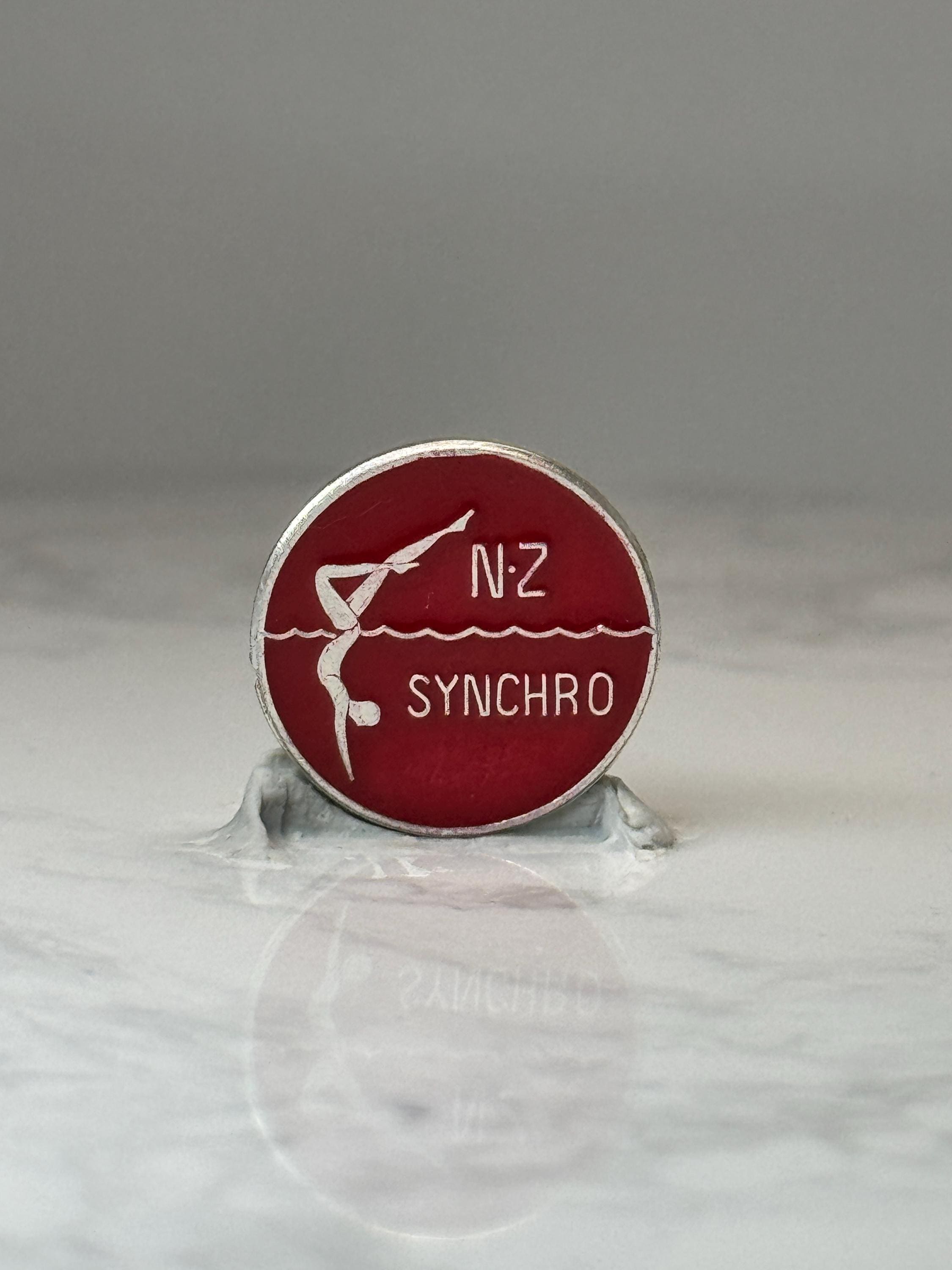 NZ Synchro Swimming Pin: Red Enamel Silver Tone - Sports Accessory