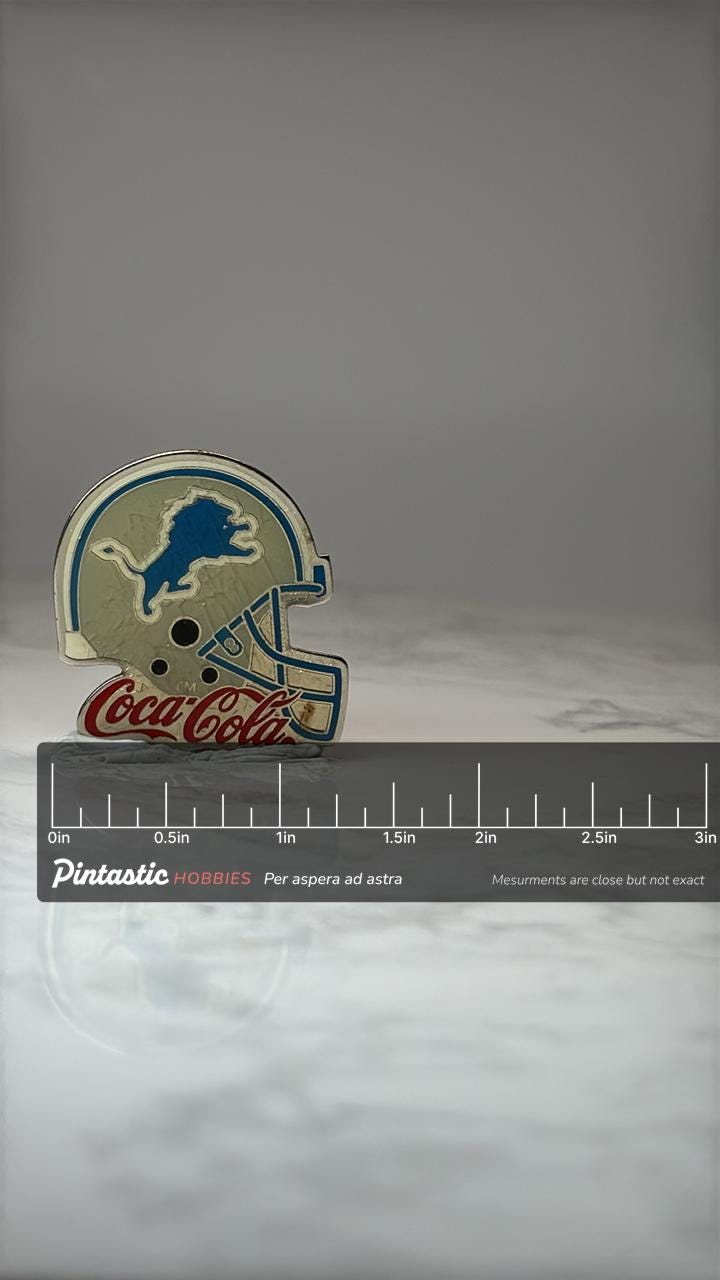 Detroit Lions Helmet Pin: Silver Enamel - Coca Cola NFL Promo with ruler overlay for size reference