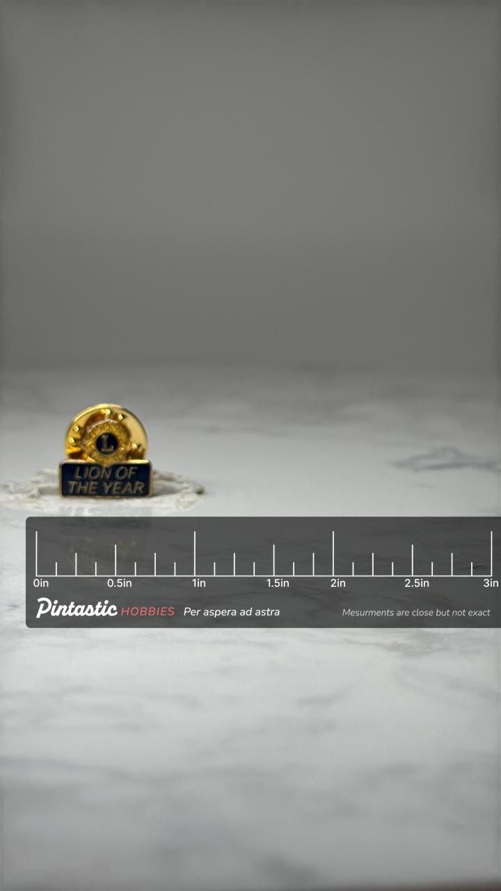 Lions Club Lion of the Year Pin: Gold Tone Enamel - Service Award with ruler overlay for size reference
