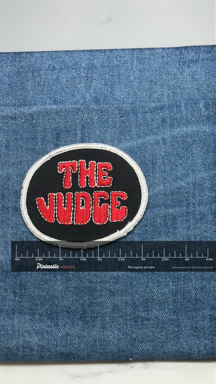 The Judge Patch: Red on Black Oval - Novelty Accessory with ruler overlay for size reference