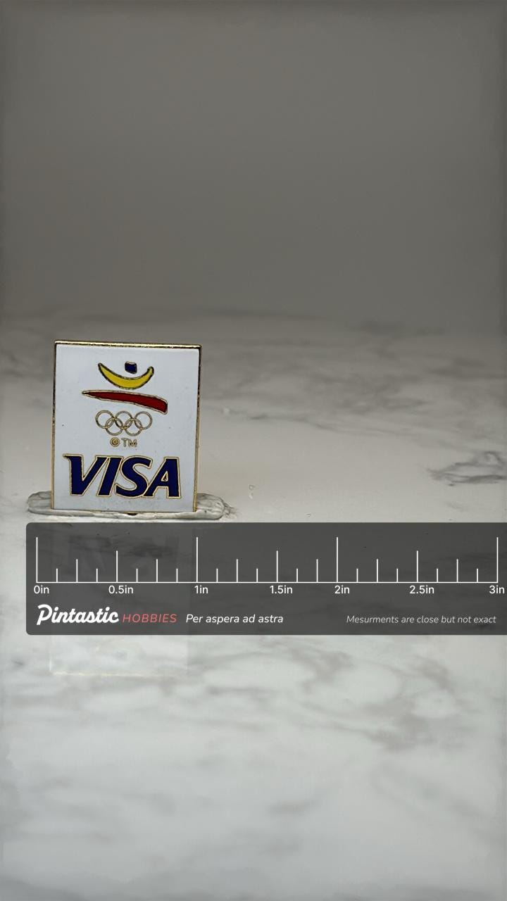 Visa Olympic Logo Enamel Pin: White Gold Tone - 1990s Sponsor Accessory with ruler overlay for size reference