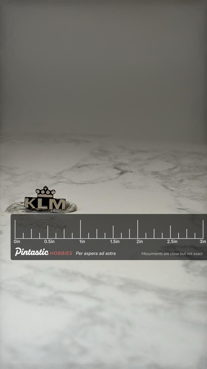 Vintage KLM Royal Dutch Airlines Crown Logo Lapel Pin Black Silver Airline with ruler overlay for size reference