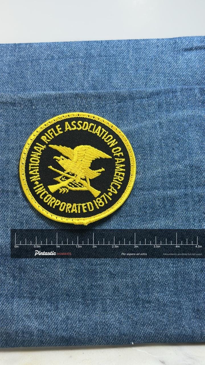 National Rifle Association Patch: Black Gold - Firearm Org with ruler overlay for size reference