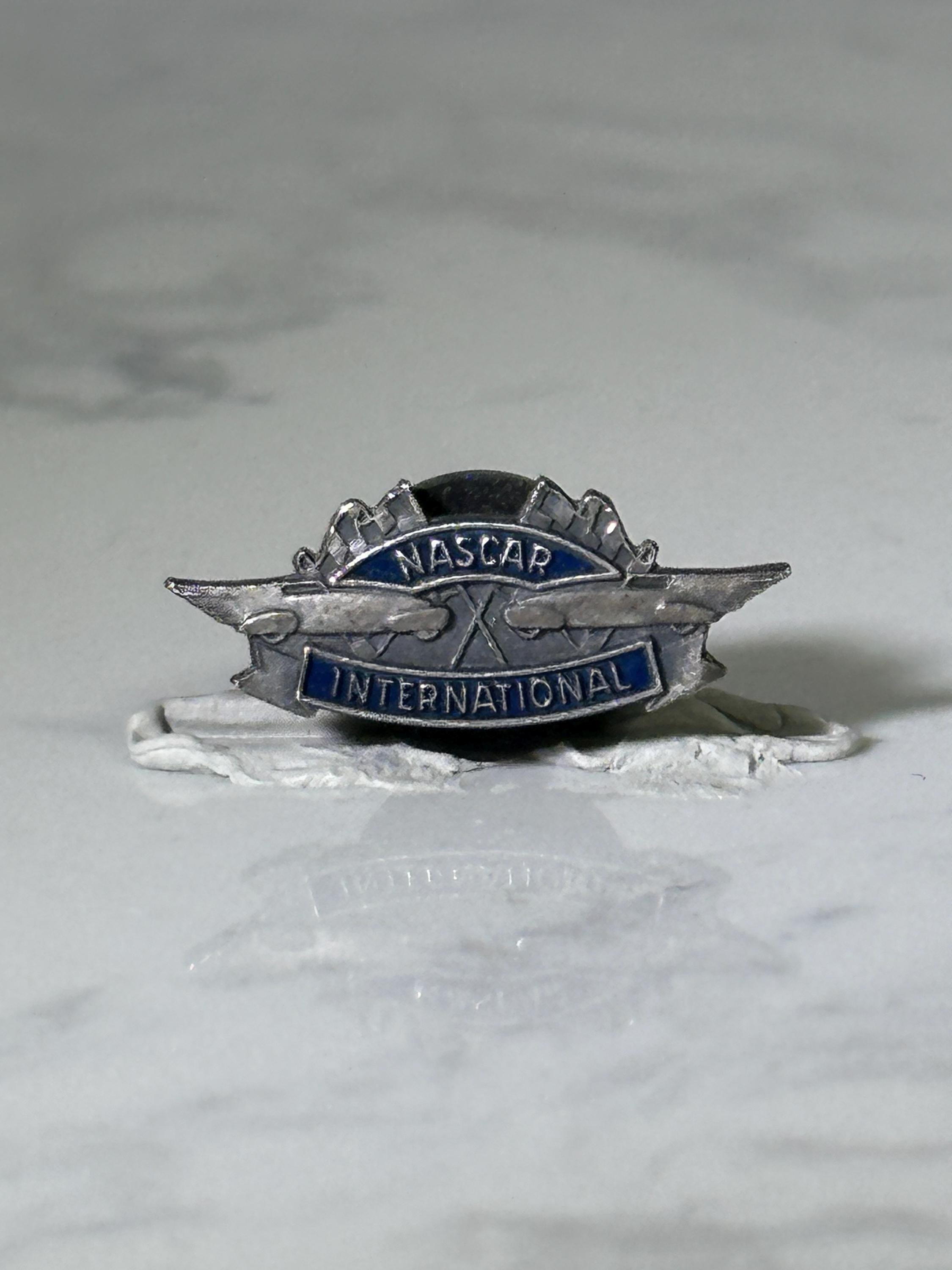 Nascar international pin: silver & blue enamel - vintage racing accessory
