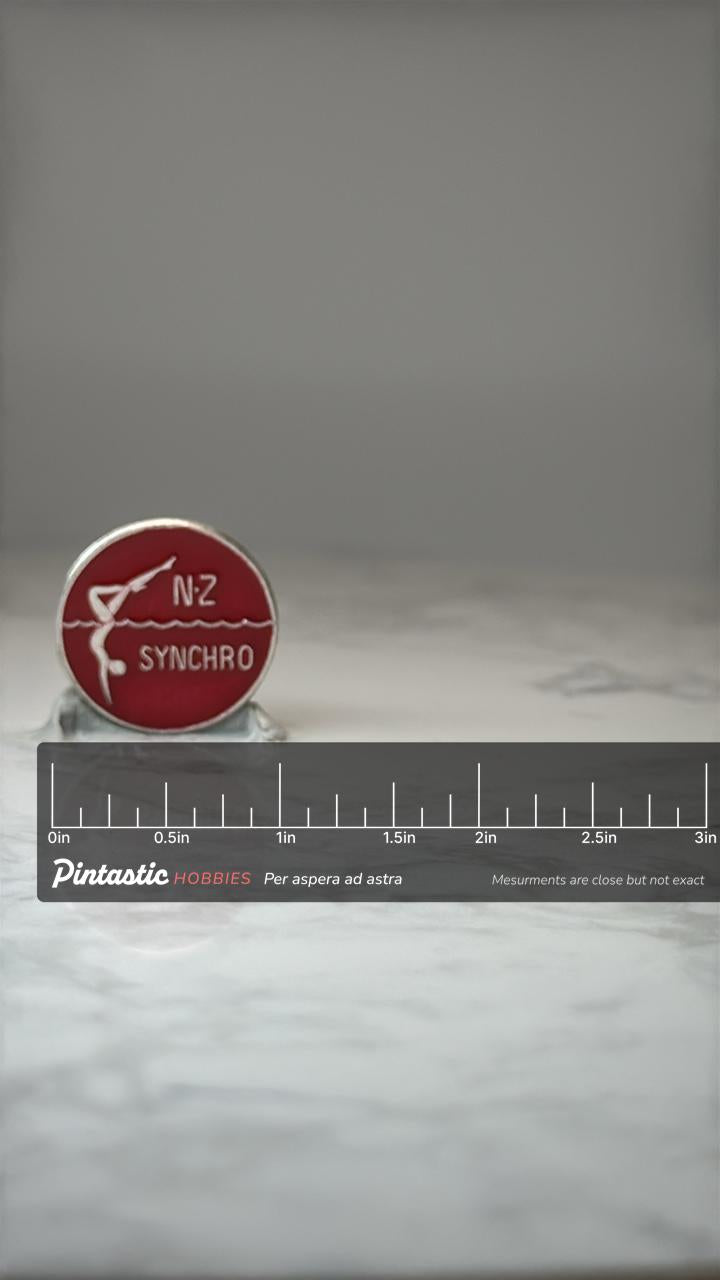 NZ Synchro Swimming Pin: Red Enamel Silver Tone - Sports Accessory with ruler overlay for size reference