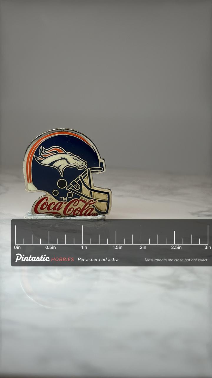 Denver Broncos Helmet Lapel Pin: Enamel Coca Cola NFL Accessory with ruler overlay for size reference