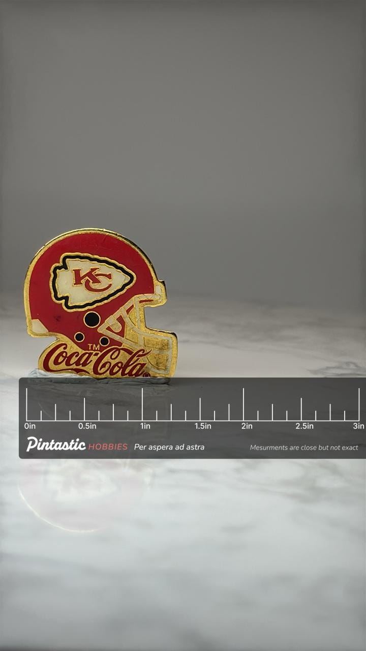 Kansas City Chiefs Helmet Pin: Red Gold Enamel - NFL Coke with ruler overlay for size reference