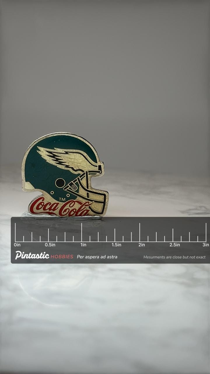 Philadelphia Eagles Helmet Pin: Green Enamel - Coca Cola NFL with ruler overlay for size reference