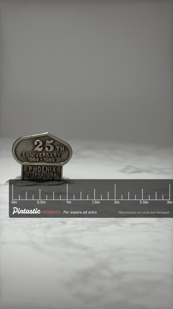 Phoenix International Raceway Pin: Silver Tone - 25th Anniversary with ruler overlay for size reference