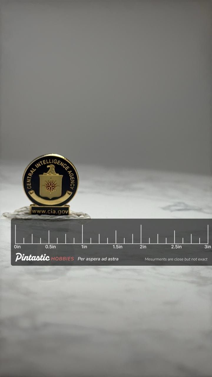 CIA Emblem Lapel Pin: Gold Tone Enamel - US Intelligence Accessory with ruler overlay for size reference