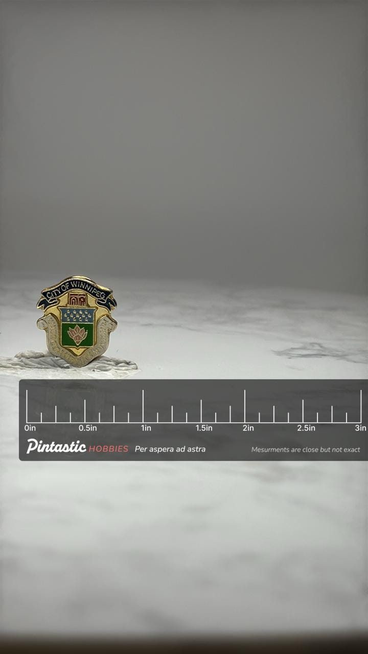 City of Winnipeg Crest Lapel Pin: Gold Tone Enamel - Canada Souvenir with ruler overlay for size reference