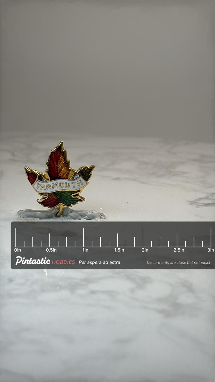Yarmouth Maple Leaf Souvenir Pin: Gold Tone Enamel - Canada Travel Accessory with ruler overlay for size reference