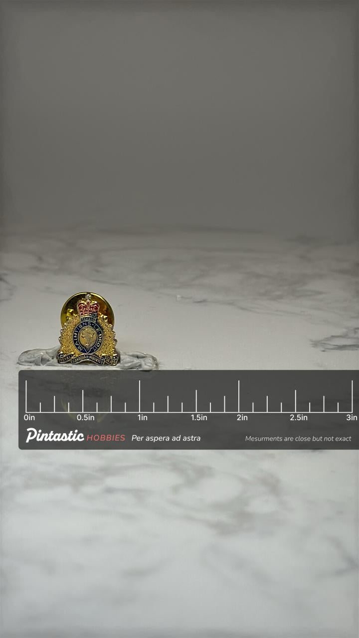 Canadian Mounted Police Lapel Pin: Gold Tone Enamel - RCMP with ruler overlay for size reference