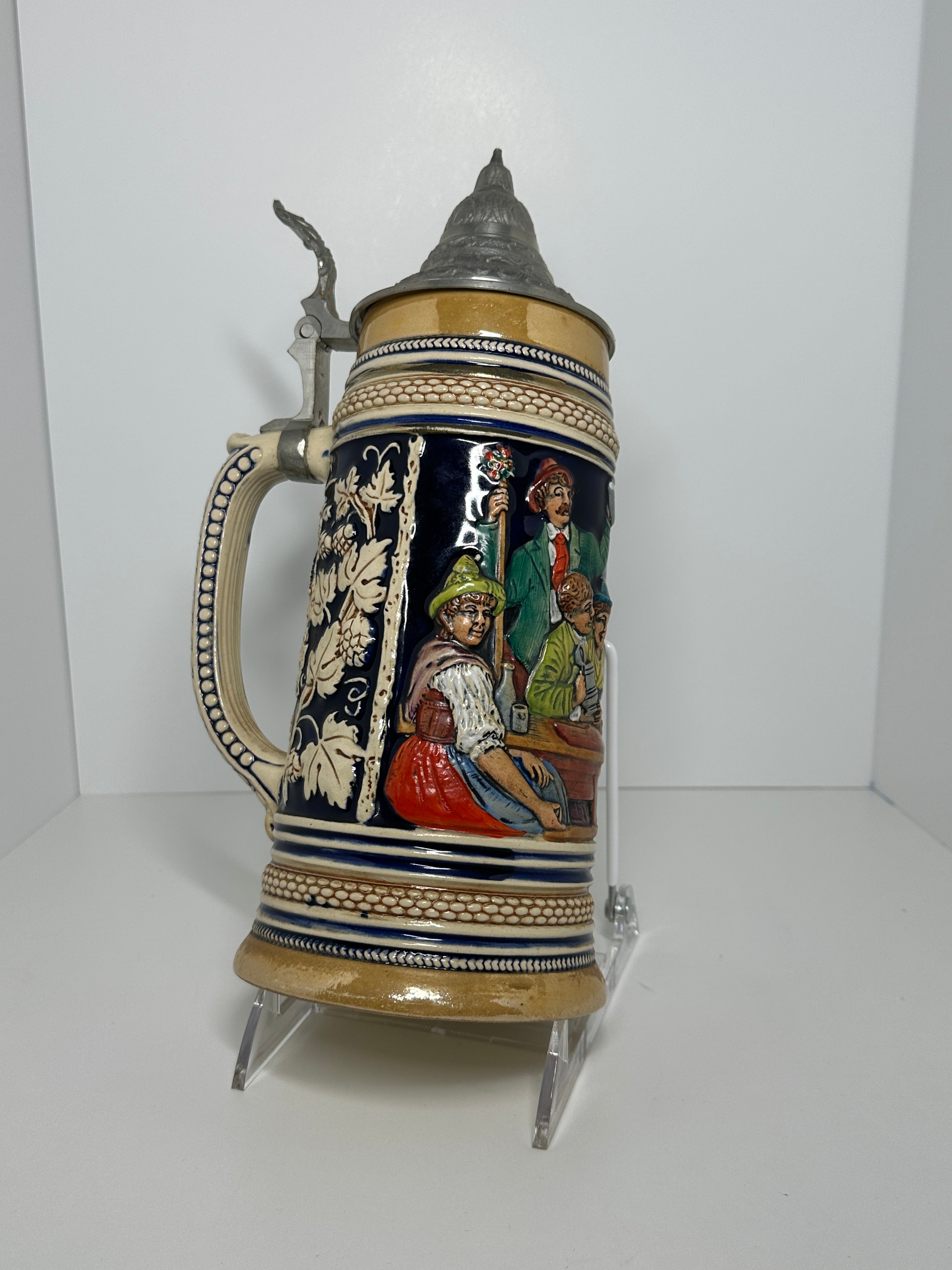 German decorative beer stein with pewter lid, blue and tan raised relief village design, marked 160